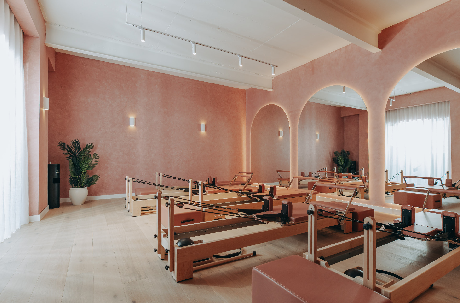 POSÉ Pilates Mosman studio — pink walls, illuminated arch and reformers